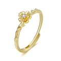 Detailed view of the 18K gold floral ring featuring a white zircon and branch texture - October