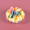 Realistic artificial fruit tart model with faux berries on a pink background - Blueberry