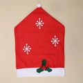 Red velvet Christmas chair cover featuring white snowflakes and green holly berry decor - Snowflake Print Chair Cover