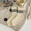 Creamy white mid-calf knit socks with black geometric jacquard patterns on ribbed cuffs - One Size / Beige Geometric