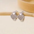 Silver heart hoop earrings with micro-pave cubic zirconia and flower detail on a branch - Small Flower Heart Pendant Pavé Huggie-Silver