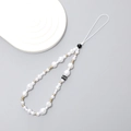 Elegant pearl phone wrist strap with gold and black beads on a white wave tray - Irregular Style With Letter C (K2230)