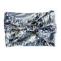 Close-up of blue and white paisley yoga headband made of soft stretch cotton fabric - Light Blue White Paisley
