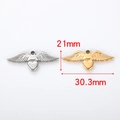 Detailed size view of silver and gold heart wing pendants measuring 21mm by 30.3mm - Heart Wings