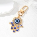 Vintage Hamsa Hand Schlüsselanhänger mit blauem Evil Eye Anhänger und Strasssteinen - Gold mit Royalblau Auge Stil