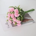 Pink artificial carnation bouquet with green leaves and white baby's breath accents - Peach Pink
