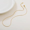 Golden moonstone necklace with extension chain and S-clasp on white surface - 04 Hammered Round Chain