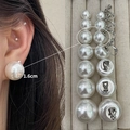 Elegant white faux pearl stud earrings in 1.6cm size displayed on a beige jewelry tray - 3875-1.6cm Spiral Ear Clip