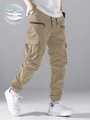 Dettagli dei joggers cargo kaki con vita a coulisse e grandi tasche laterali - S / Cachi