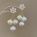 Macro detail of lily of the valley earrings with white petals and golden tassels - Lily of the Valley Tassel Earrings / Silver Pin-Gold-White