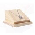 Silver interlocking ring pendant necklace with clear gemstone on a wooden display stand - 1909 Slanted Necklace Holder