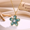 Close-up of golden flower necklace with teal enamel petals and a center white pearl - Necklace / Light Sea Blue