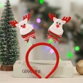 Detail of Christmas headband featuring red reindeer horns with spring bouncers and bows - Deer