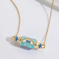 Golden Evil Eye cylinder necklace with WILL lettering and blue enamel detail - Blue