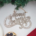 Dettaglio della scritta Merry Christmas dorata con glitter su tela bianca e pino - Oro champagne
