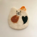 Handmade wool felt cat coaster featuring an orange ear and a black heart pattern - White Cat Face