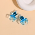 Detail view of two blue ocean-style glass octopus pendants with clear hanging loops - Blue