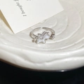 Macro shot of silver unicorn ring with white enamel and sparkling zircon details - Unicorn / Ring - Silver