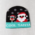 Detail of black Christmas knit hat with cyan brim showing cool Santa and reindeer patterns - Deer and Santa Claus
