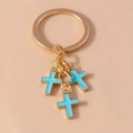 Vintage golden keychain featuring light blue enamel cross pendants for bag decor - Blue