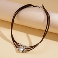 Detailed view of triple-layer brown suede choker with a silver heart-shaped paw print pendant - Brown Heart Claw Style