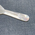 Polished white mother of pearl cosmetic spoon with engraved OMOS logo on handle - 7.3cm / Laser Logo Engraved Style