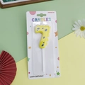 Number 7 birthday candle in yellow with blue dots, cartoon dinosaur themed party decor - Yellow Dinosaur Number 7