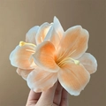 Elegant peach and white artificial lily flower hair clip held by hand for women - Type A Orange Lily Hair Clip