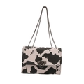 Chic black and white cow print leather shoulder bag with metallic chain strap and lock - Cow Print