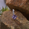 Macro shot of S925 silver pendant with square purple gemstone on a natural rock texture - Natural Amethyst Square Pendant Silver