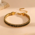 18k gold plated titanium steel bracelet with green gemstones on beige background - Gold Green Zirconia (K208)