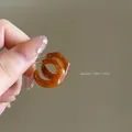 Detail shot of amber resin C-shape hoop earrings showing 1.9cm dimensions - Irregular Twisted Hoops (35#)