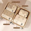 Beige travel storage bags set with mesh panels arranged in suitcase for organization - Beige 4-Piece Set