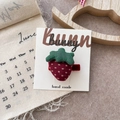 Detailed view of handmade strawberry fabric hair clip with red polka dots and green leaf - Strawberry Hair Clip