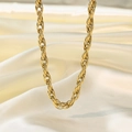 Detail of a chunky gold twisted rope chain necklace on elegant white silk background - H1217 Red Cliff Style Gold Necklace