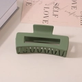 Matte green rectangular hair claw clip with wavy teeth shown on a book and card - #9 Matte Olive Green - 10.5cm / Bulk (No Packaging)