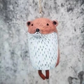 Close-up of handmade resin capybara wind chime with rustic textures and stripes - Marmot