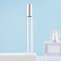 Clear glass essential oil roller bottle with silver cap on a white display stand - 10ml Silver