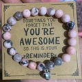 Pink zebra stone beaded bracelet with silver heart pendant on a kraft display card - Pink Zebra With Card Style Three