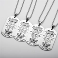 Macro detail of stainless steel dog tag pendants with inspirational engraved messages - Necklace / Silver
