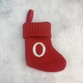 Red knitted Christmas stocking featuring a white embroidered letter O with hanging loop - Letter O