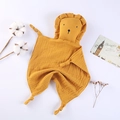 Close-up of ginger cotton gauze baby security blanket with cute lion head and knot corners - Turmeric
