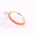 Close-up of golden adjustable ring with orange enamel detailing and crystal prop - Adjustable Open / Orange