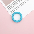 Close-up of a 25mm light blue matte painted metal spring ring for DIY crafts and bags - Lake Blue