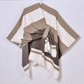Detail of striped knit shawl with elegant front tie and soft asymmetric draped texture - Horizontal Striped Tassel Side Tie / Coffee