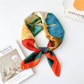 Silk-textured floral scarf with bold red and blue abstract patterns tied in a ring - Colorful Ginkgo Leaves Orange