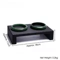 Dark green jade bangles displayed on a minimalist black wooden textured stand - Small Chair Bracelet Display (Black)