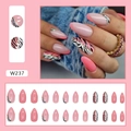 Close-up of pink and zebra print almond press-on nails with gold foil accents - Zebra Stripes (W237) / Glue Type