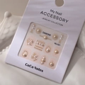 Detailed view of MJ-021 nail art set with pearls and golden metallic studs on white card - MJ-021 Gold Stamping