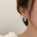 Elegant gold pearl drop earrings featuring multiple white pearls on a model's ear - Grape Cluster Pearl Hoop (MY33890)